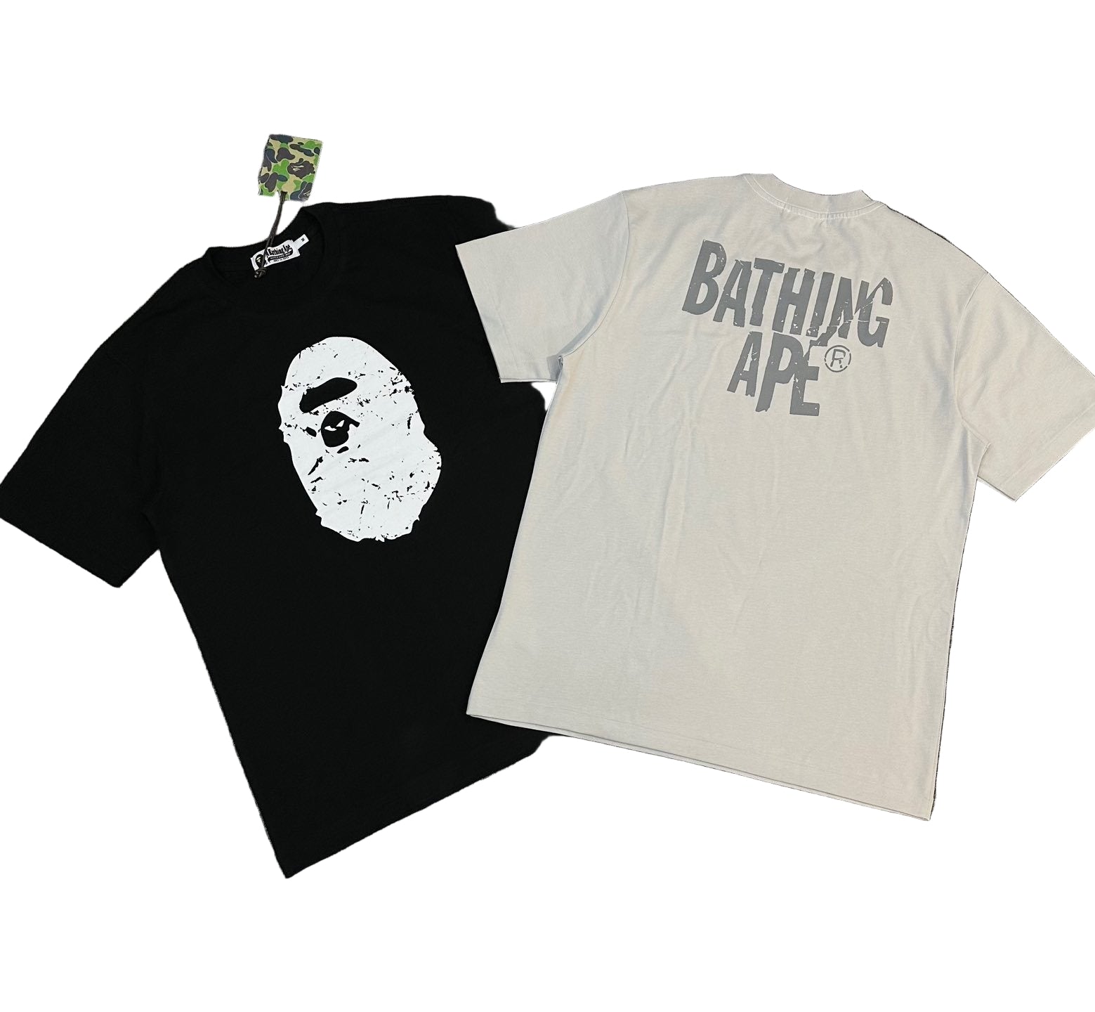 Black and white t-shirts with 'Bathing Ape' logo on a gray background