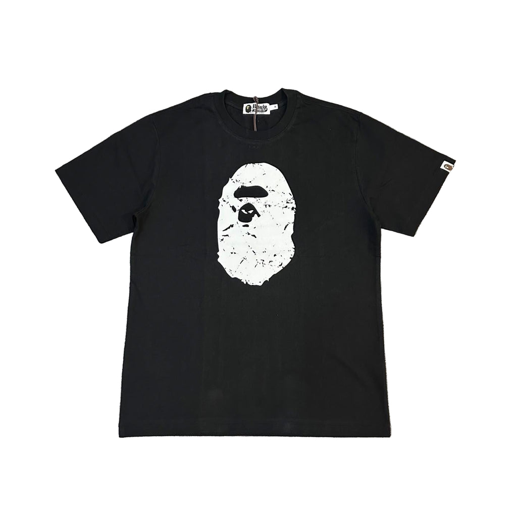 Black t-shirt with a white graphic on a gray textured background