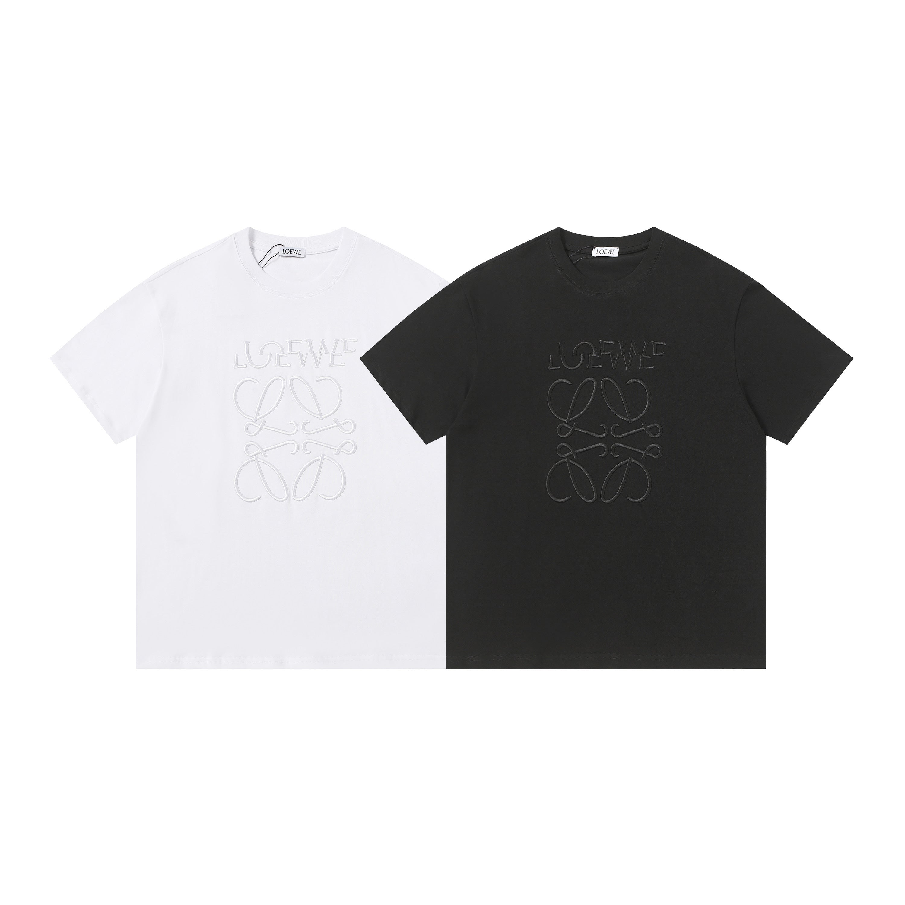 Black and white t-shirts with embroidered designs on a white background